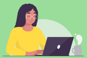 Woman happily typing on a laptop and drinking a cup of tea