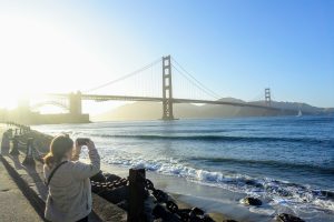 Woman photographing the Golden Gate Bridge