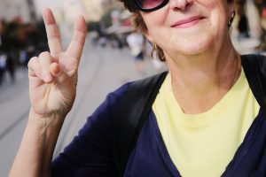 Woman giving peace sign.