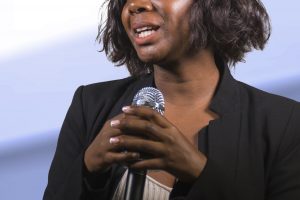 Woman presenter with microphone.