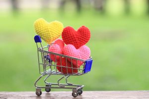 Crocheted hearts in a mini shopping cart