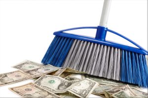 Broom sweeping up money